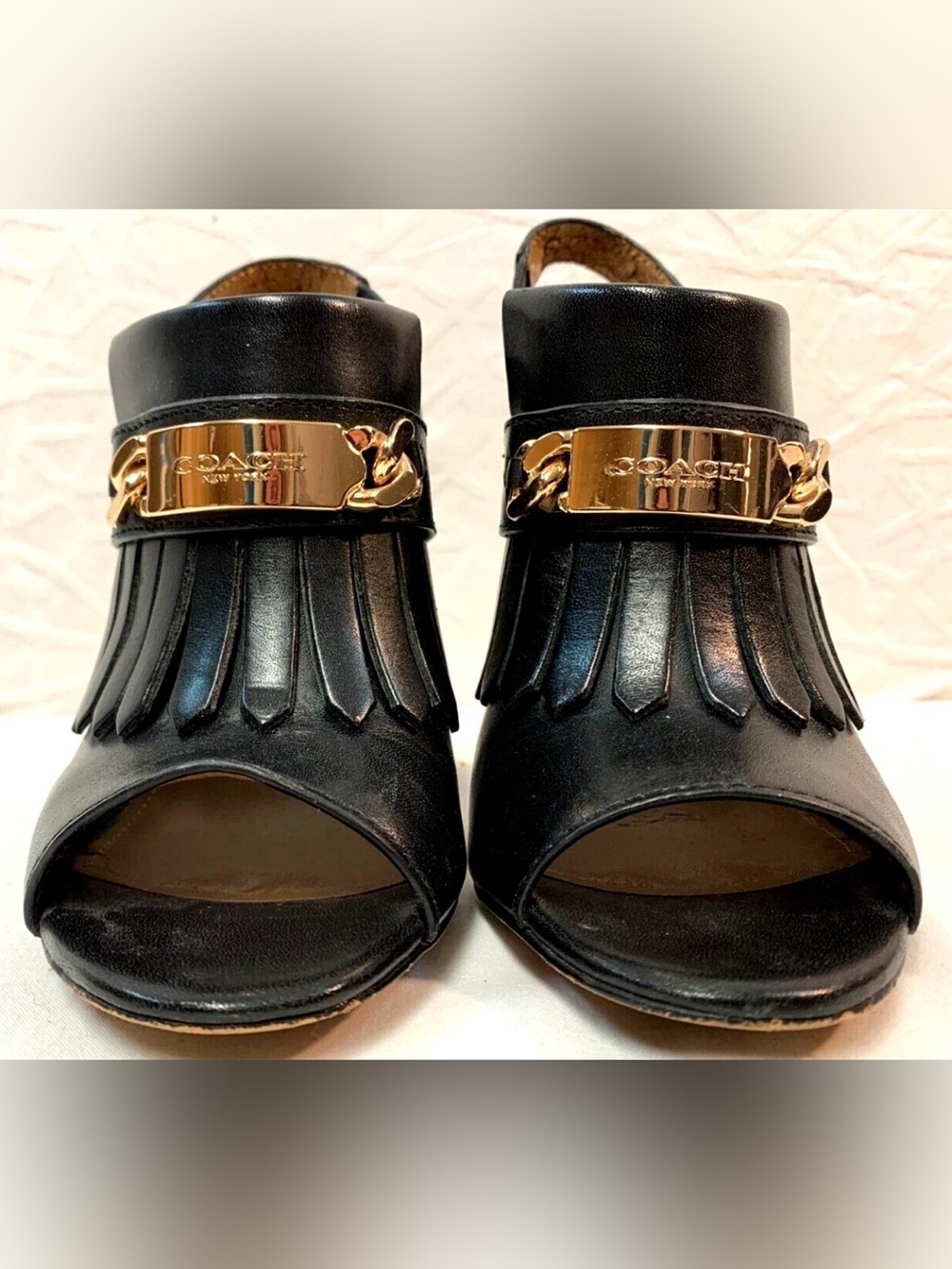 (CALLOUT) COACH Black Leather Fringe Open-Toe Mules with Gold Hardware